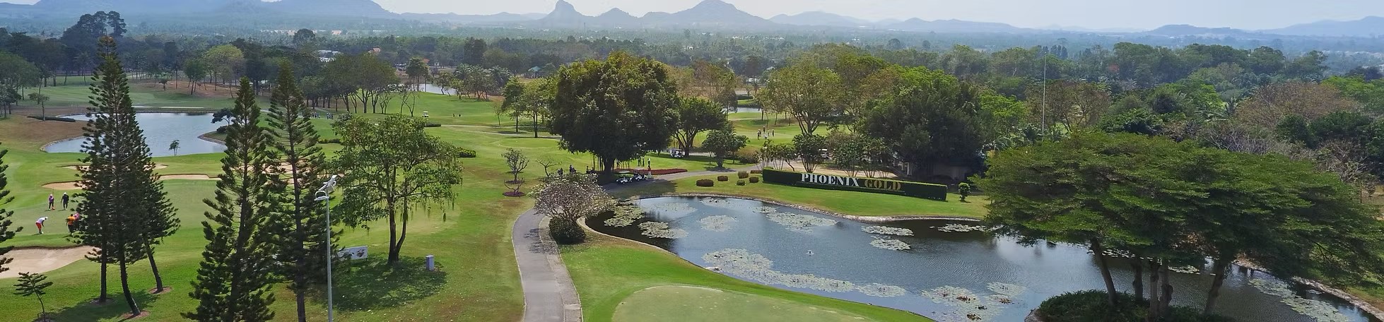 Aerial view of Phoenix Gold Golf and Country Club, Pattaya, with the course sign and lakes